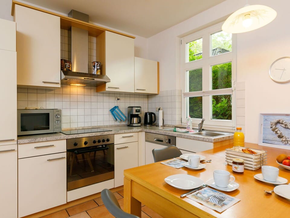 Countertop, Cabinetry, Property, Table, Kitchen Stove, Kitchen, Kitchen Appliance, Sink, Lighting, Interior Design