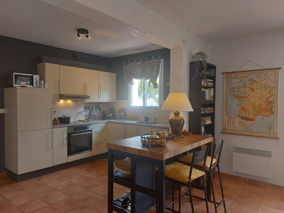 Furniture, Interior Design, Countertop, Kitchen, Flooring, Kitchen Appliance, Chair, Cabinetry, Wood, Kitchen & Dining Room Table