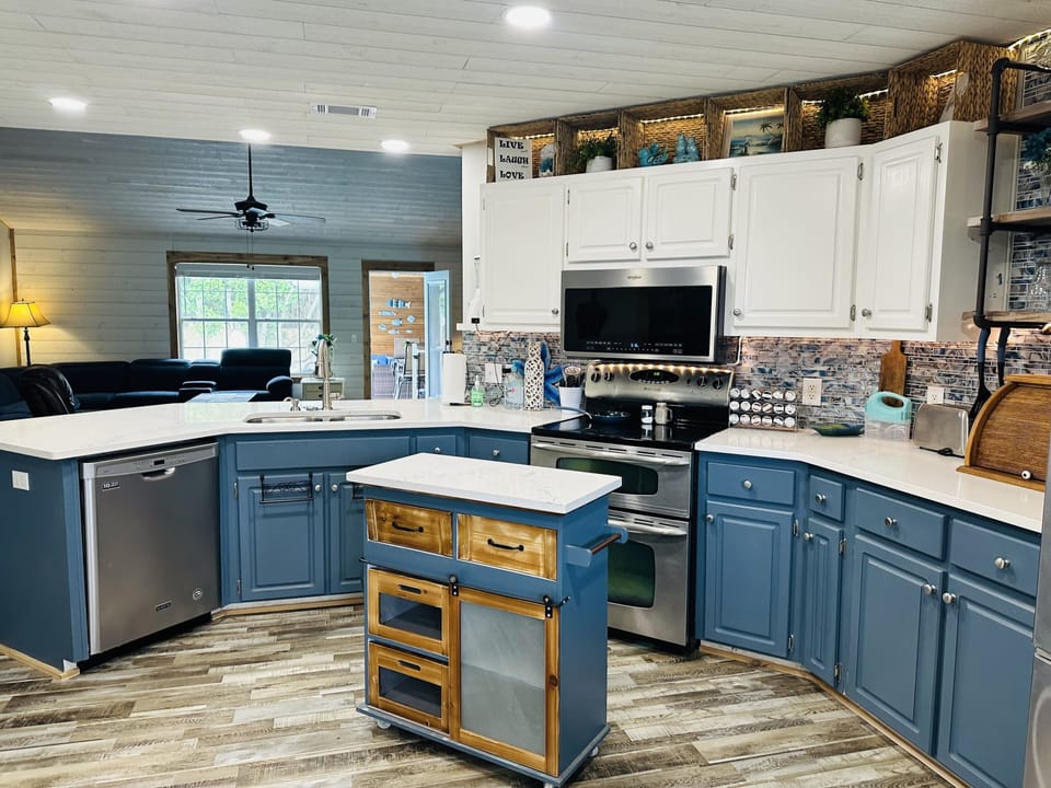 Stainless steel appliances, movable island, new quartzite counters, LED lights 