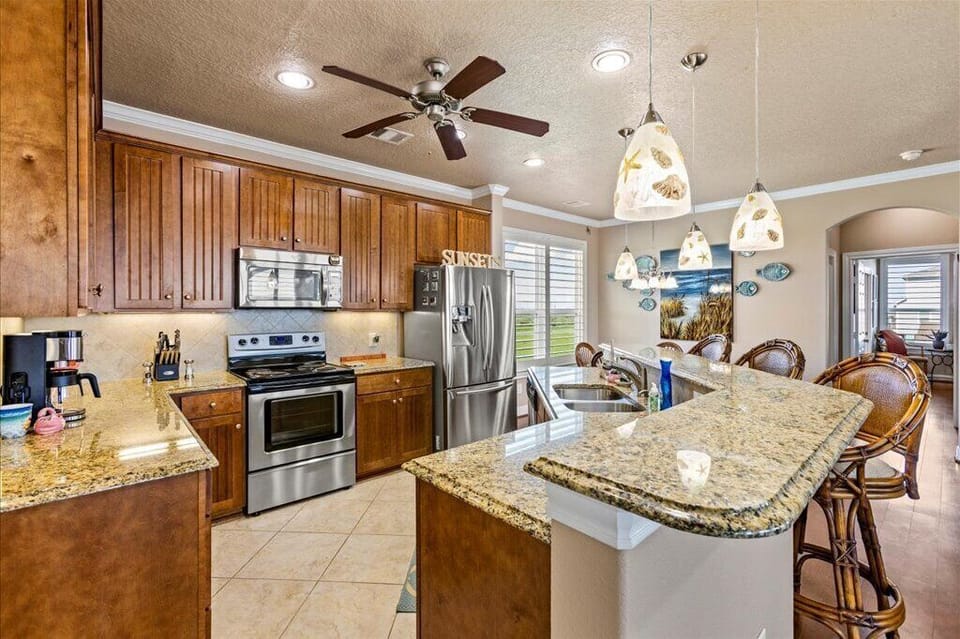 Modern kitchen equipped with high-end appliances and a granite island