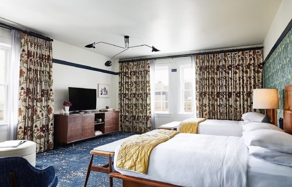 Spread out comfortably with two plush beds and airy corner windows
