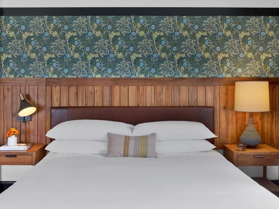 Drift off on crisp linens framed by warm, wood accents.