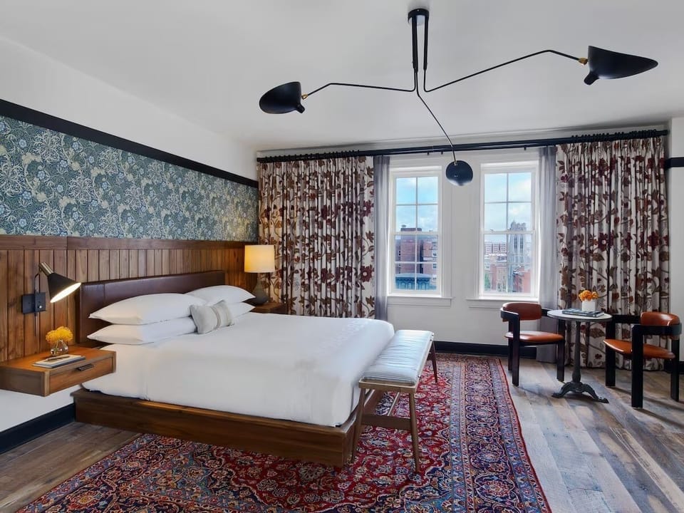 Unwind in a sunlit king room with skyline views.