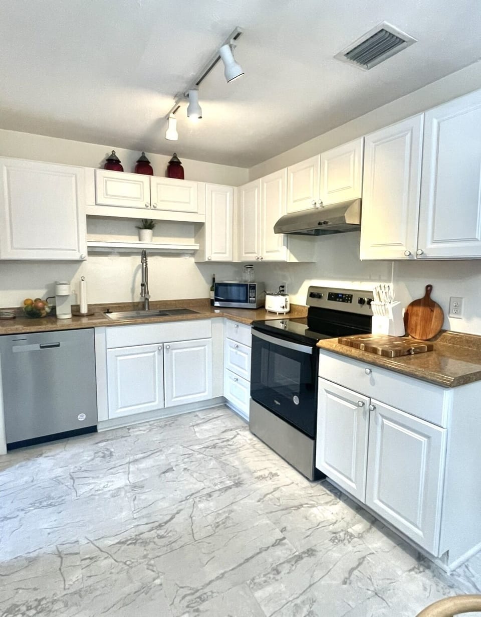 Fully stocked kitchen with oven, dishwasher and microwave.