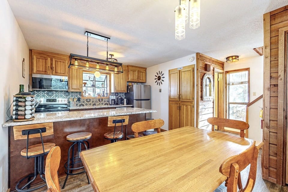 Dining area and breakfast bar next to kitchen