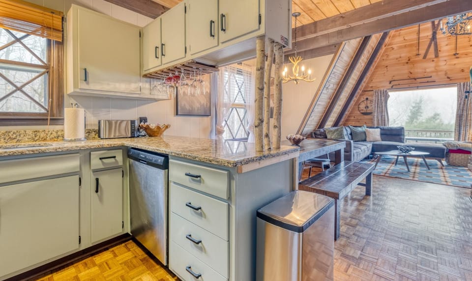 The fully equipped kitchen with granite countertops and stainless steel appliances adjoins a welcoming dining area, ideal for family meals and gatherings.
