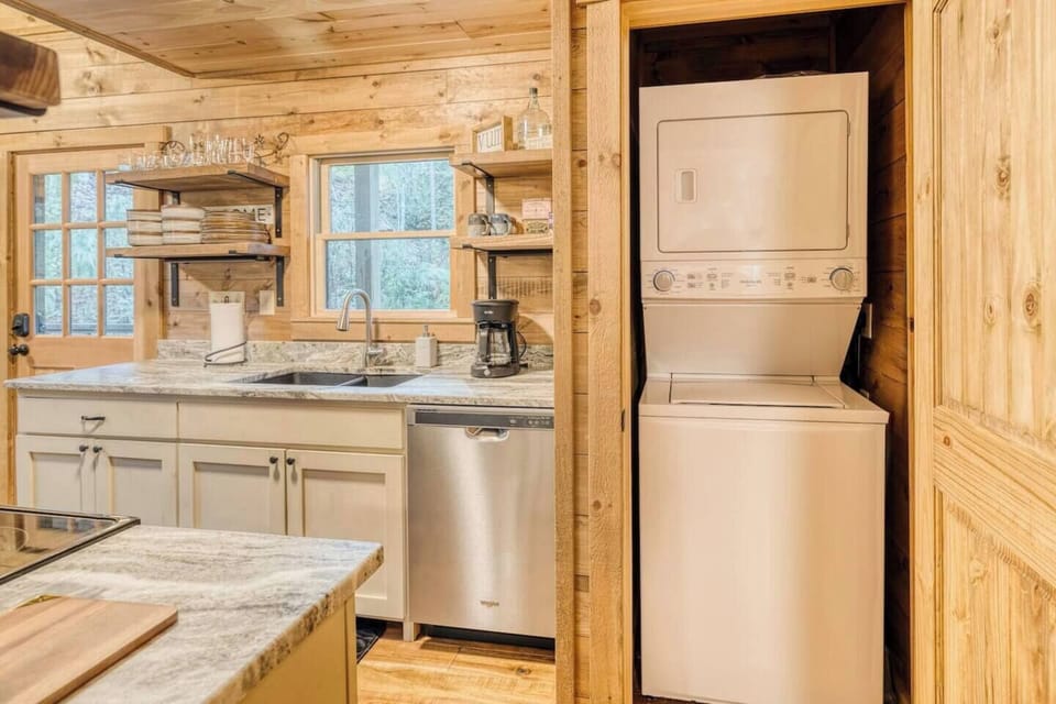 Step into our clean kitchen area, where the rustic ambiance is complemented by modern amenities, offering the perfect blend of convenience and wilderness charm in our cozy cabin retreat.