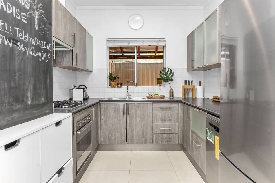 Modern, fully-equipped kitchen with a gas stove, oven, dishwasher, and ample counter space, perfect for preparing meals.