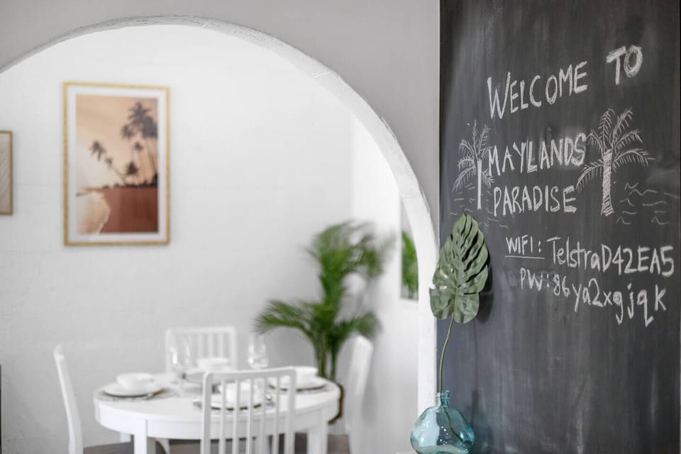 Charming chalkboard wall providing a personalized welcome and essential connectivity information.