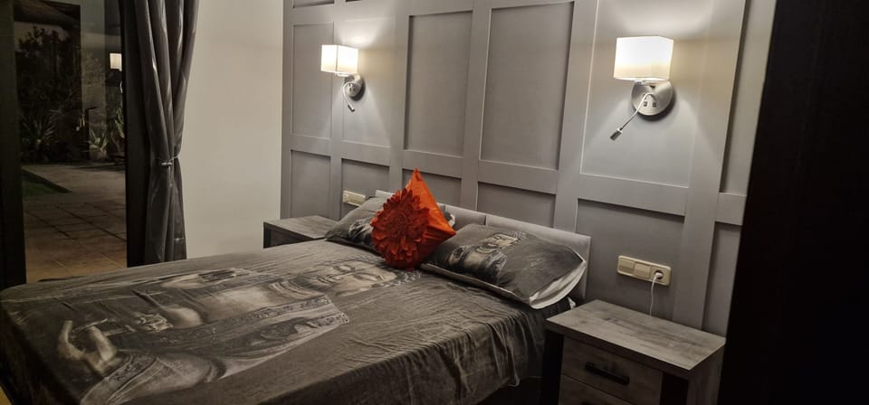 Master bedroom with patio doors leading to the private garden, with hot-tub