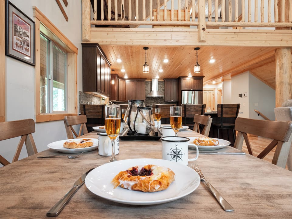 Enjoy a delicious meal with family and friends in this inviting dining space, where rustic charm meets modern comfort for the perfect mountain retreat.