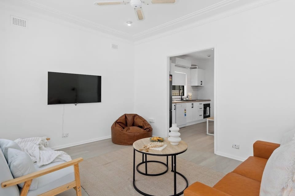 The living room is warm and welcoming with sofas and a bean bag chair to cuddle up on.