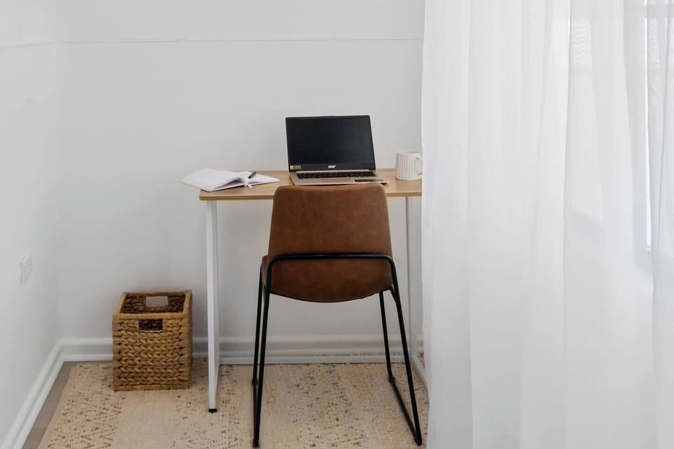 A dedicated office with a desk and chair caters to those working remotely.
