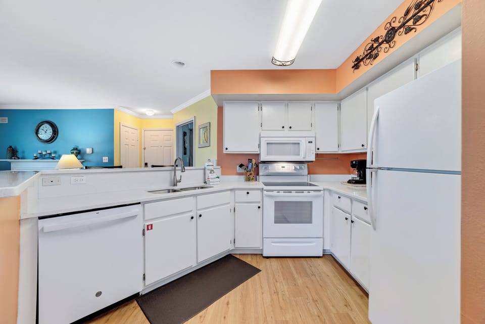 The stunning white kitchen adds a touch of sophistication to the space and is equipped with everything you need to enjoy this home away from home retreat.
