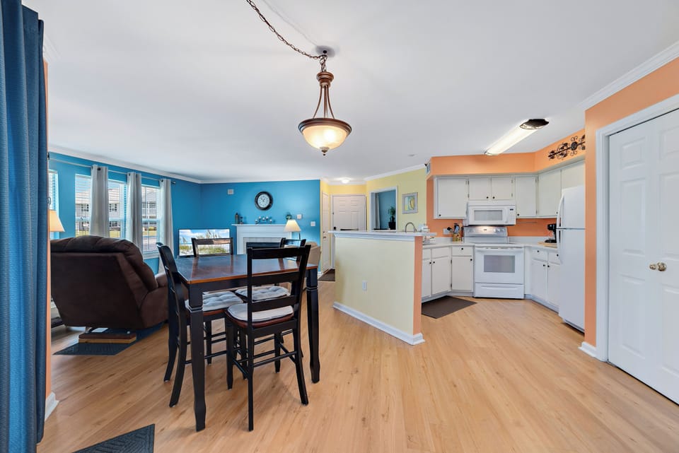 This open-concept design effortlessly connects the living, dining, and kitchen areas, creating a seamless flow perfect for modern living.