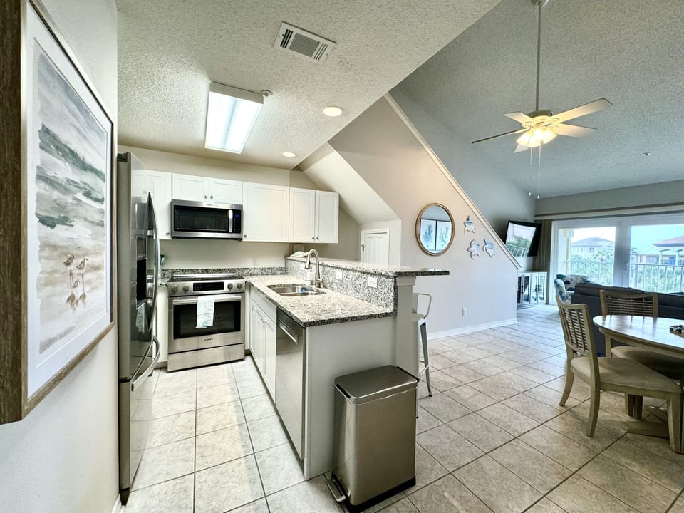 Kitchen with stainless appliances. Microwave and dishwasher. Fully stocked.