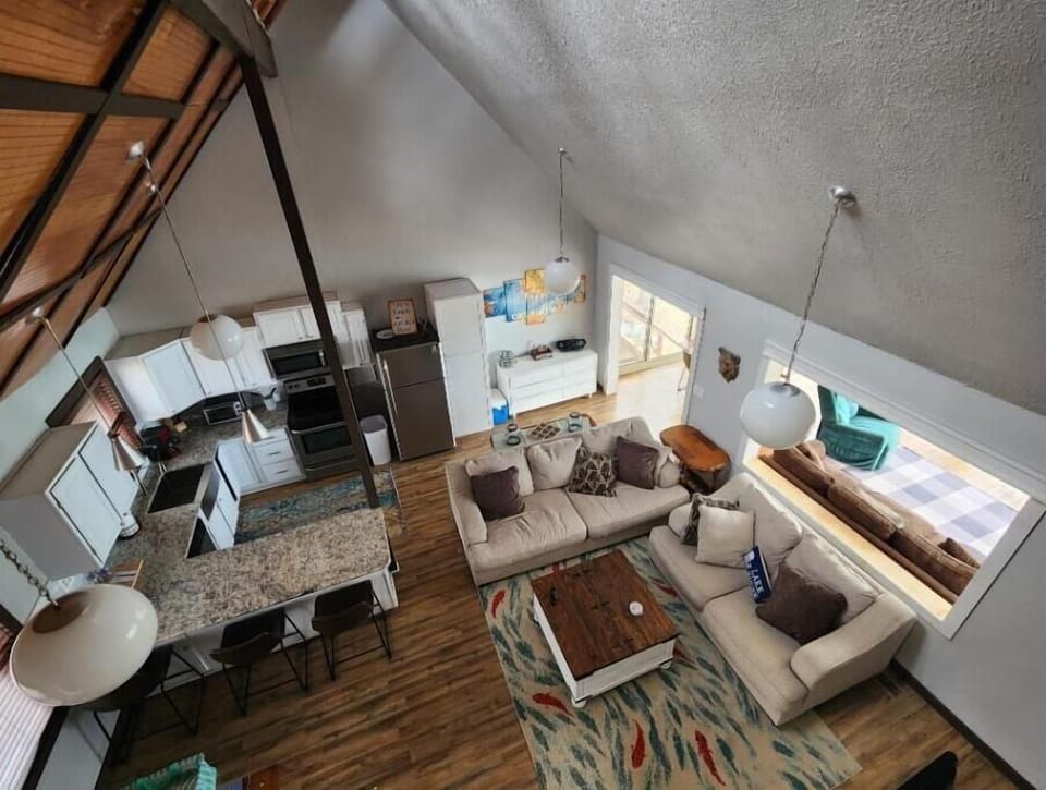 Cozy couches, spacious kitchen, and dining areas.