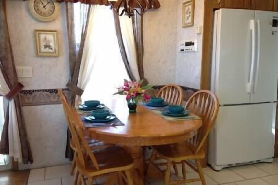 One of two eating areas. Large refrigerator.