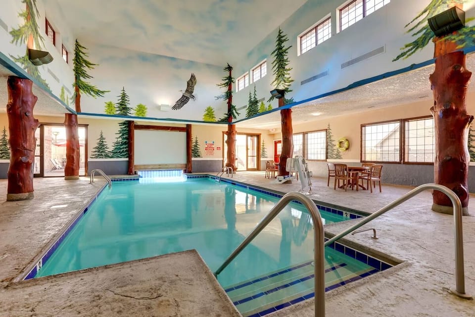 Dive into the stunning indoor pool beneath whimsical forest murals.