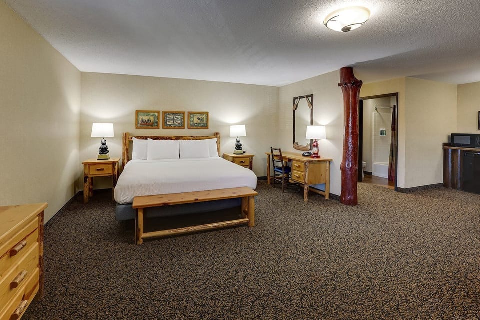 Drift off fast in a serene king bed with warm lighting.