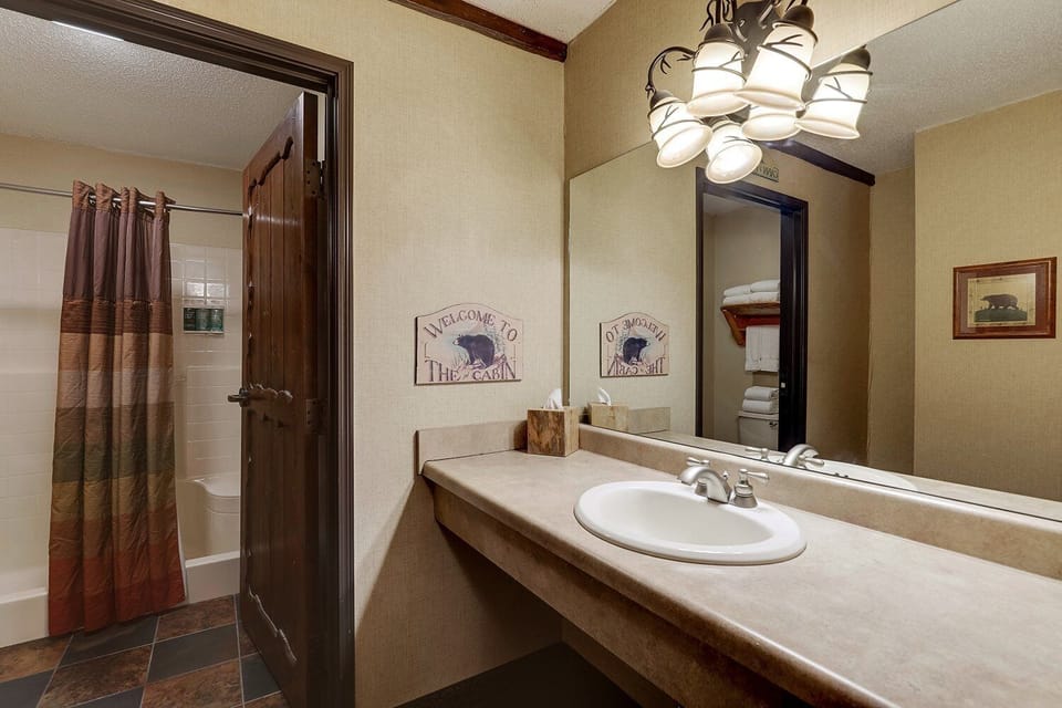 Refresh in the bright vanity area with shower and plush towels.