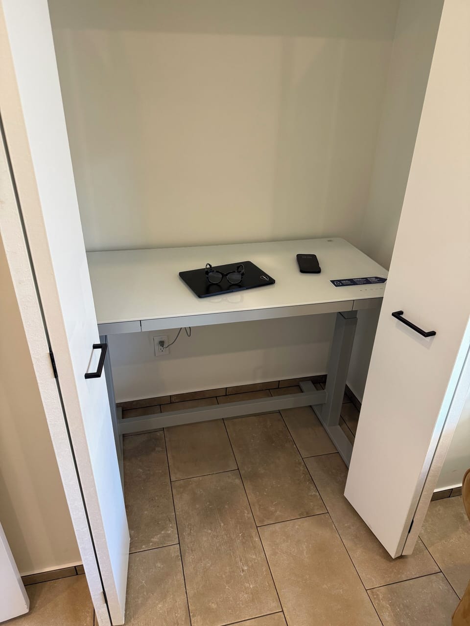 Office features worksation with adjustable height desk with USB charging ports. 