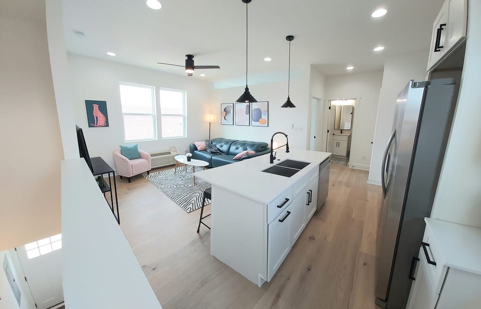 Located above a 2 car garage, with private entrance seen at bottom of stairs.