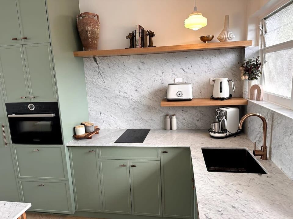 Georgeous sage and Carrara marble full kitchen with Leibherr built in fridge freezer, Bosch combination oven and dishwasher.