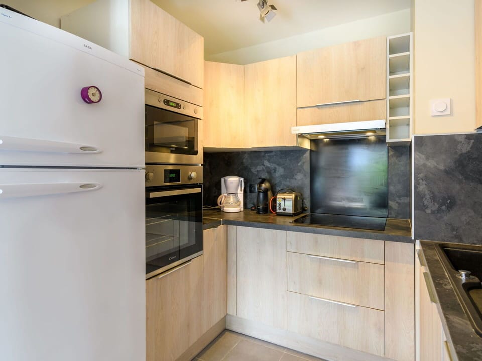 Cabinetry, Property, Countertop, Kitchen Appliance, Kitchen Stove, Home Appliance, Kitchen, Gas Stove, Refrigerator, Lighting