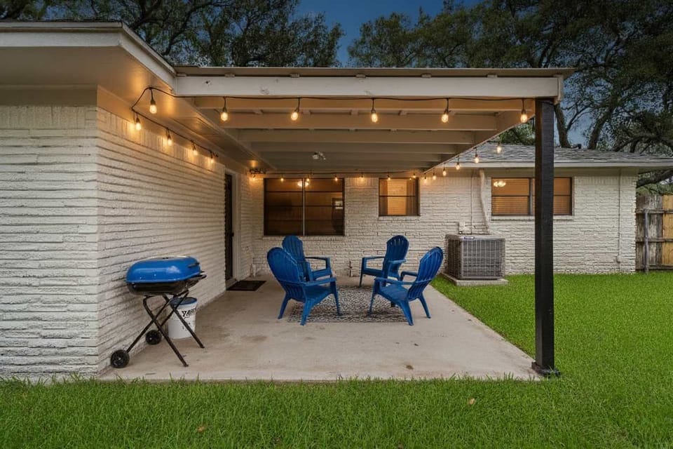 Patio Retreat: Gather around the fire pit and savor BBQ delights under twinkling string lights!