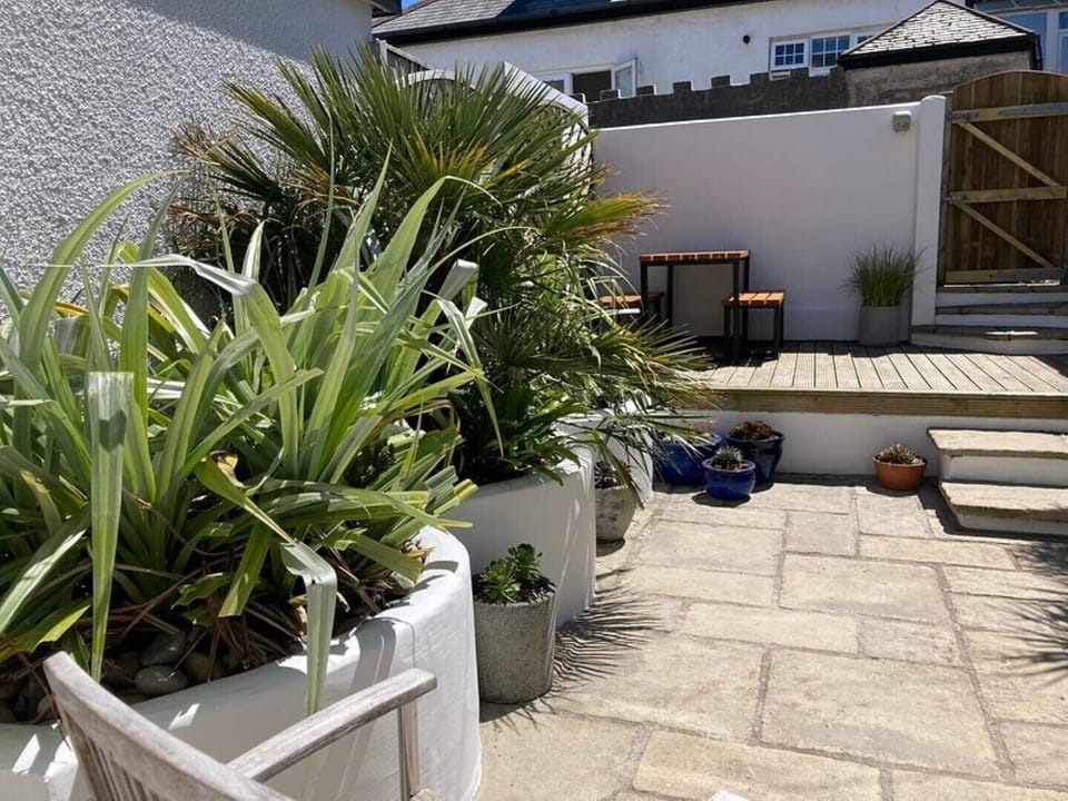 Back courtyard garden with furniture and BBQ.