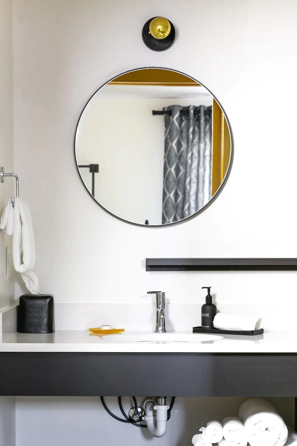 Refresh at a sleek vanity with bright, flattering lighting.