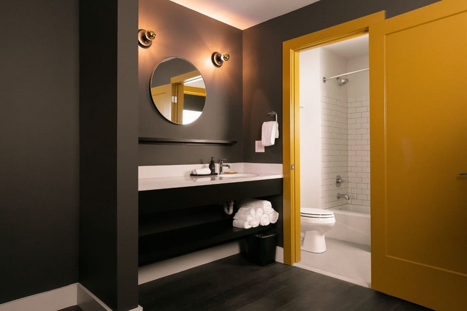 Refresh at the modern vanity with soft lighting and towels.