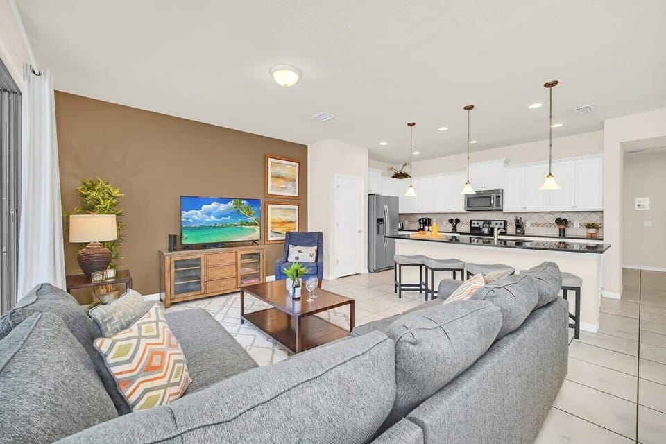 Open-concept living area with a modern kitchen and comfortable seating for relaxing or entertaining.