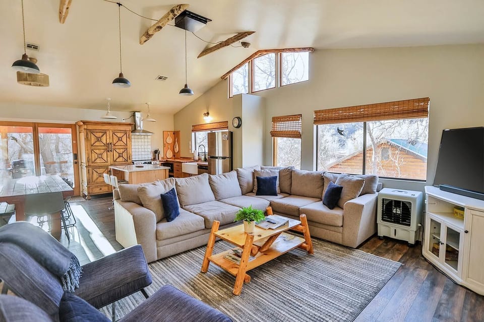 National park adventures by day, cozy comfort by night! Zen Zion Blue Jay's living room welcomes you with a sectional couch, TV, and a gas fireplace.