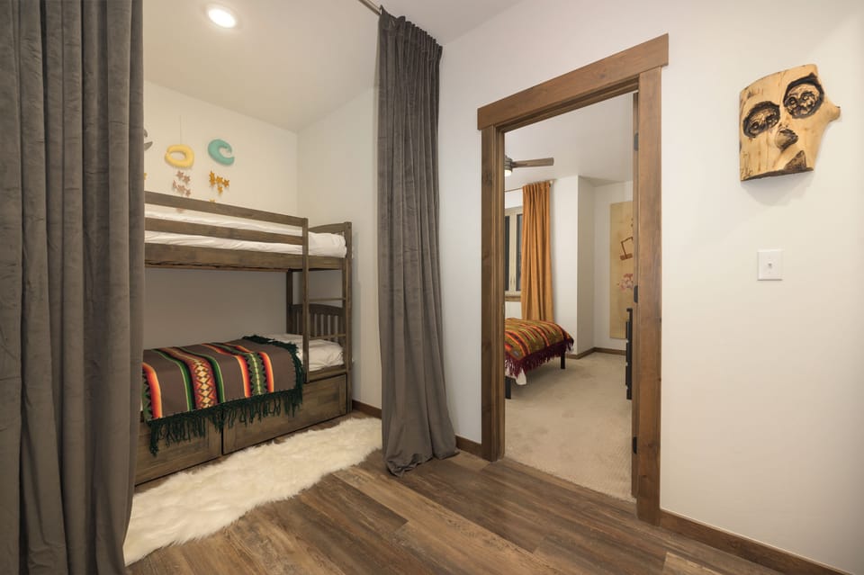 Your kids will love these cozy bunk beds, perfect for fun sleepovers and adventurous nights in this thoughtfully designed bedroom.