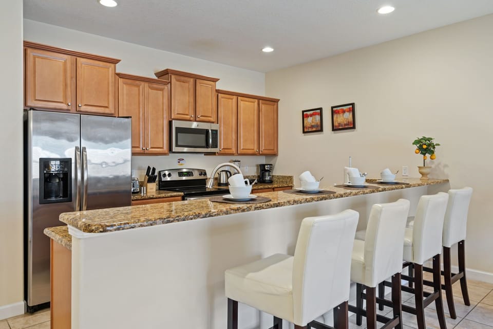Our spacious kitchen is equipped with an island and bar stools