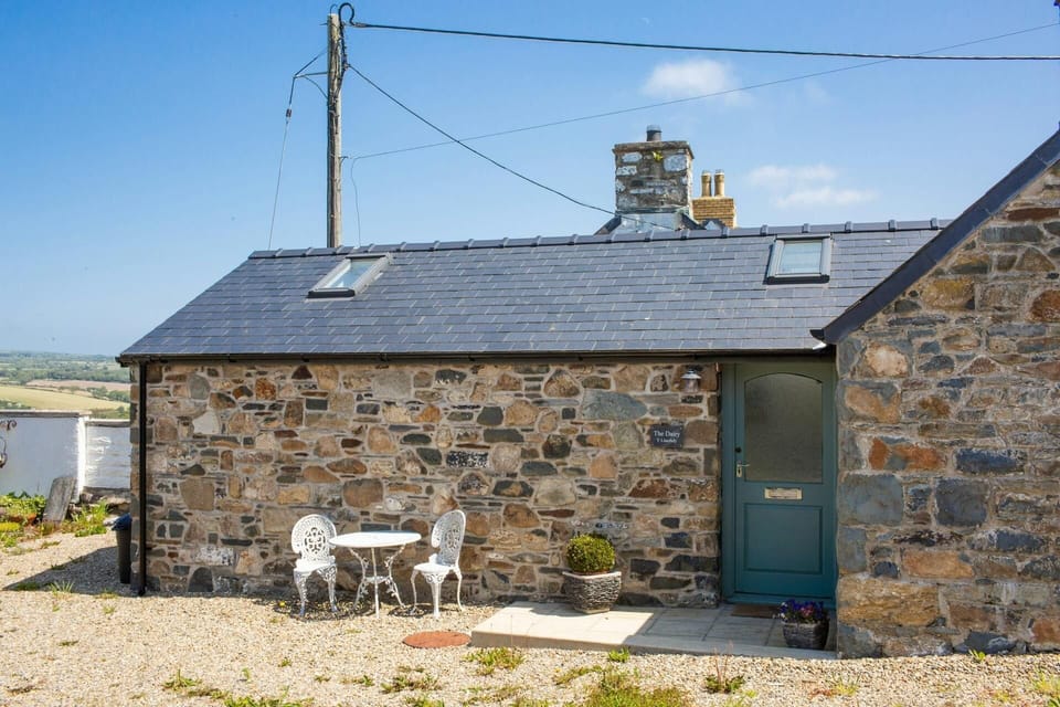 Converted dairy in the original stone. Bistro table and chairs outside front door