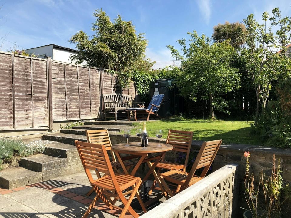 Garden with small garden table and chairs, bench