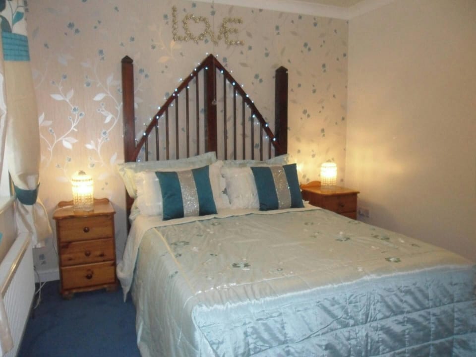 Bedroom with bed, fairy lights, bedside cabinets and lamps