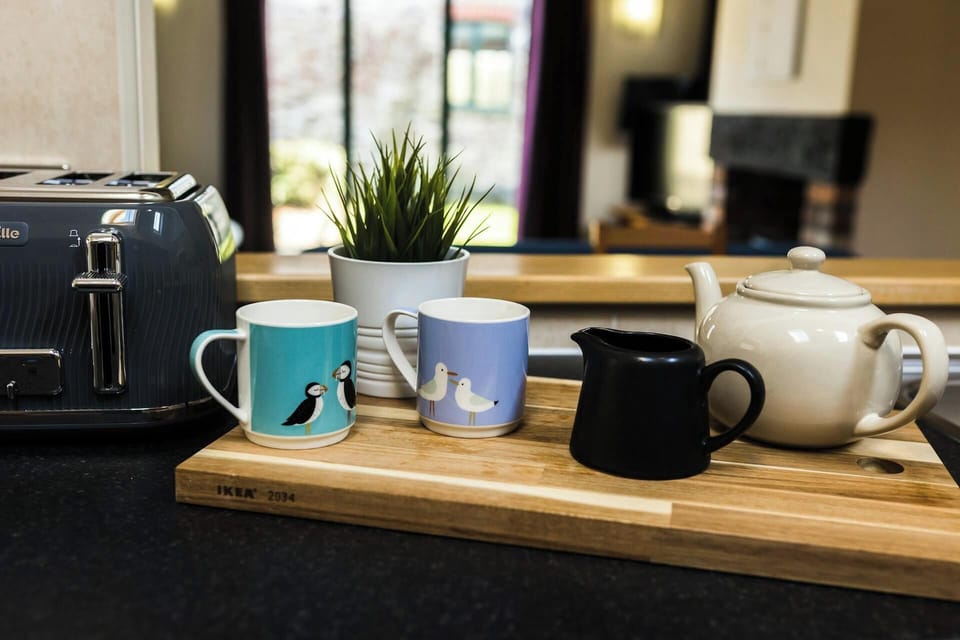 Tea cups, teapot and plant in the kitchen