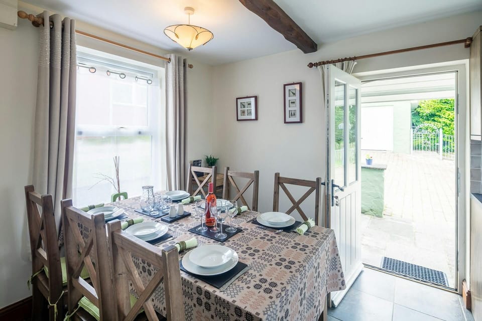 Dining table with six chairs and views of the garden