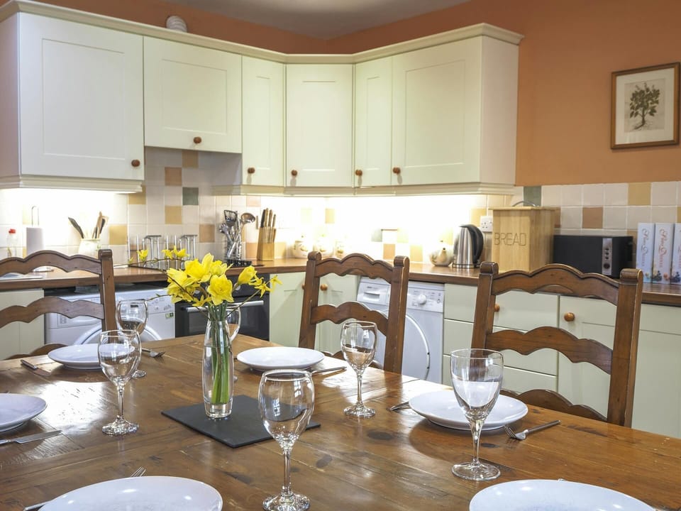 Kitchen/dining area with table laid for dinner