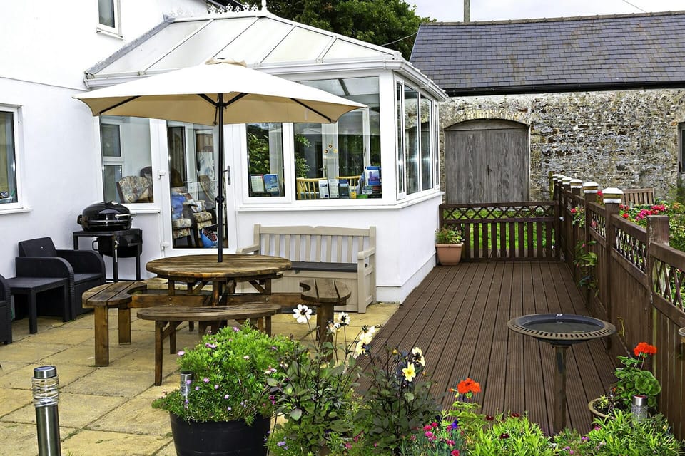Patio and deck area with seating and table and BBQ