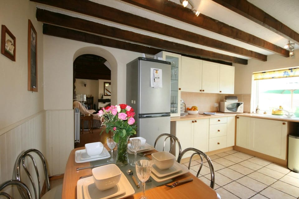 Kitchen diner with units, fridge freezer, dining table and chairs