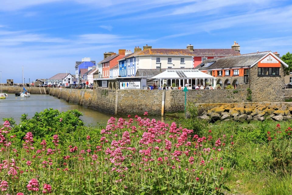 Aberaeron harbour, harbour walls, sea and coloured buildings