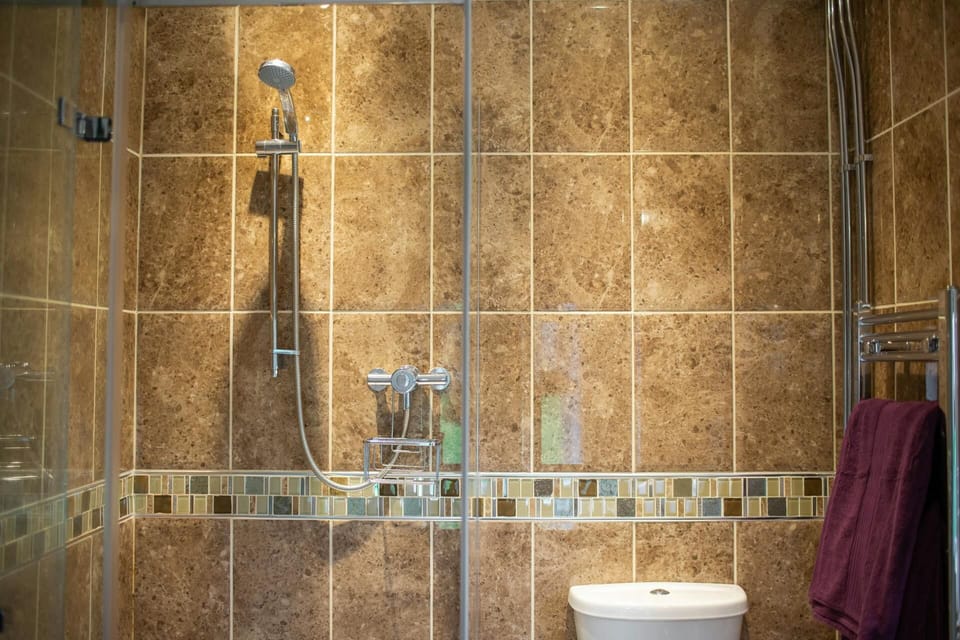 Fully tiled shower. Heated towel rail