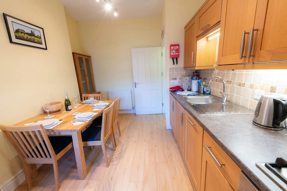 Kitchen with dining table laid for dinner for 4