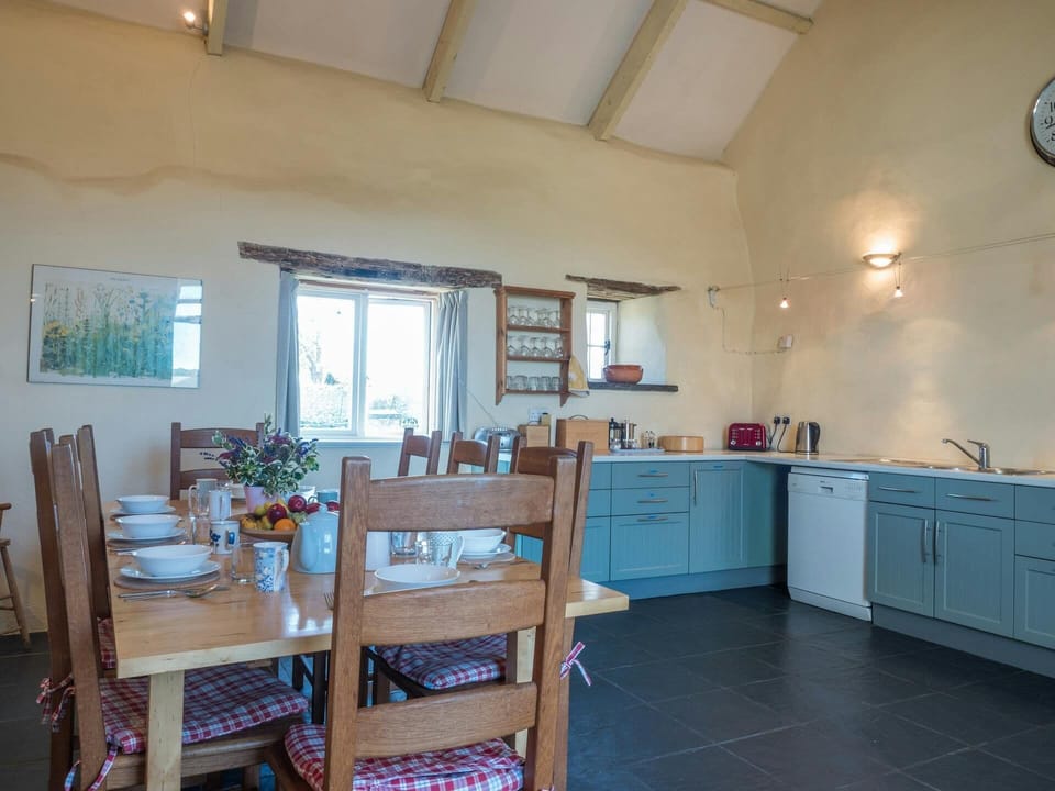 Fitted kitchen/dining area with table and eight chairs