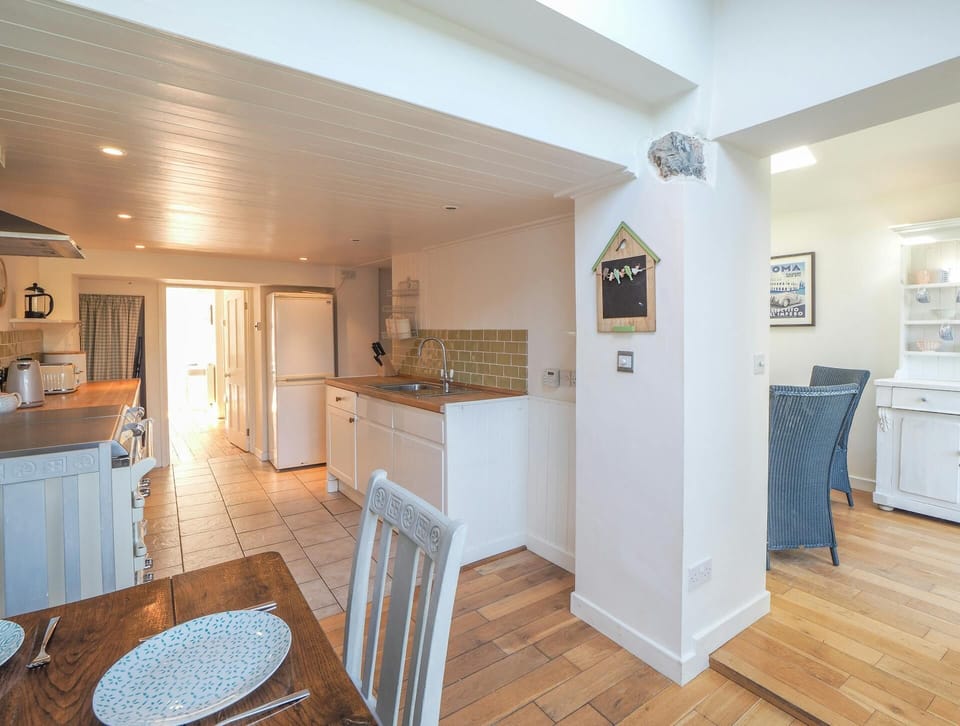 Kitchen with dining table and chairs in the foreground